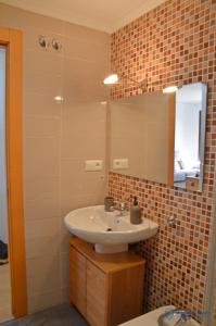 a bathroom with a sink and a mirror at Apartamento La Maquina de Coser in Colombres +9 photos