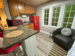 a kitchen with a counter and a red refrigerator at Cheerful Studio Close to Everything 12 in Edgecomb