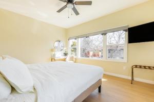 a bedroom with a white bed and a ceiling fan at Cozy Sunny Brand-new Apt 1 Block From The Beach in Long Beach