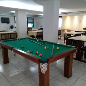 a pool table with balls on it in a restaurant at Avalon Executive in Goiânia