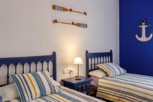 1 dormitorio con 2 camas y un ancla en la pared en Apartamento Maruja Roig 2 Playa Sur, en Peñíscola