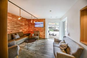 a living room with a couch and a table at Hotel Restaurant Schwörer in Lenzkirch