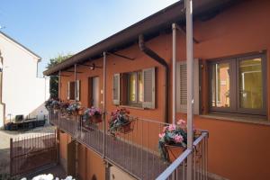 a building with flower pots on the balconies of it at Appartamenti S Onofrio Rho in Rho