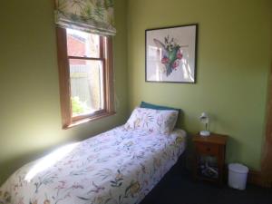 a bedroom with a bed and a window at Southern Comfort in Invercargill