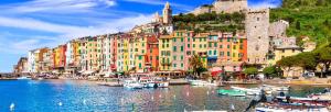 a group of boats in a body of water with buildings at CAVOUR257 in La Spezia