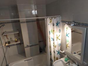 a bathroom with a shower curtain with crabs on it at PAUPET in Almería