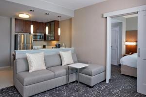 a living room with a couch and a kitchen at Residence Inn by Marriott Nashville Downtown/Convention Center in Nashville