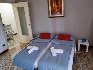 a bedroom with two beds with towels on them at casa di Angela in Acqui Terme