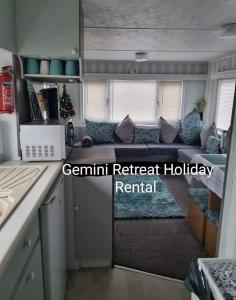 a living room with a couch in a tiny house at Stylish holiday home with fishing lakes in Fiskerton