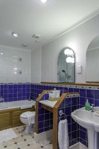 a bathroom with a sink and a tub and a toilet at Lyme Bay House in Dawlish