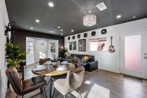 a dining room and living room with a table and chairs at Luxe Rock Bungalow in the Heart of Hollywood in Los Angeles