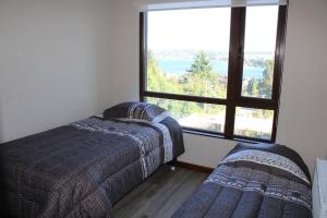 Posteľ alebo postele v izbe v ubytovaní TuArriendoCL - Cómodos Deptos en Puerto Varas