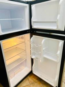 an open refrigerator with its door open and its contents at PRIVATE Cozy Guest Suite Near Hard Rock Guitar in Fort Lauderdale