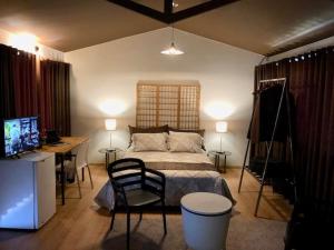 a bedroom with a bed and a desk and a computer at Villa San José in Arequipa