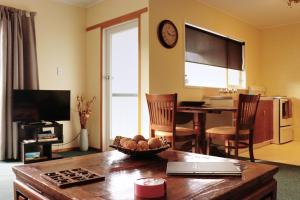 a living room with a table and a dining room at Al Louise Accommodation in Mangonui