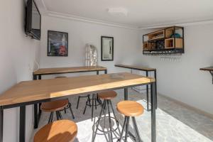 a kitchen with a table and stools in a room at villa des jasmins in Tunis