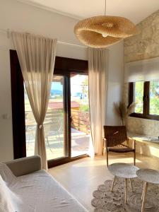 a bedroom with a bed and a sliding glass door at Palma Seaside Villa 1 in Sarti