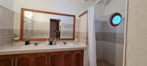 a bathroom with two sinks and a large mirror at CASONA DE LOS VIRREYES in Villa de Leyva +20 photos