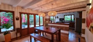 a large kitchen with a table and some windows at CASONA DE LOS VIRREYES in Villa de Leyva