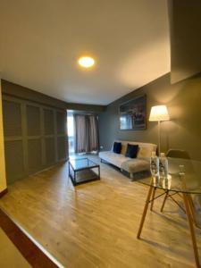 a living room with a couch and a table at Serendipia Beautiful loft in San isidro 202 in Lima
