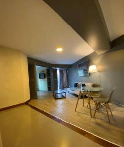 a living room with a table and chairs and a couch at Serendipia Beautiful loft in San isidro 202 in Lima