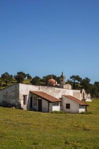 an old building in a field next to a field at Cabaña Corazon de Calixto 