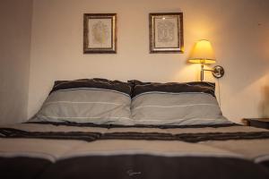 a bedroom with a bed with two pictures on the wall at Cabaña Corazon de Calixto 