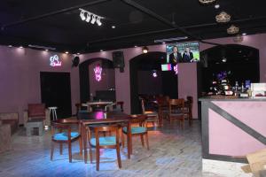 a restaurant with wooden tables and chairs and a tv at El Khan Sharm Hotel in Sharm El Sheikh