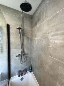 a bathroom with a shower and a tub and a sink at Seaforth Deluxe 2 bedroom apartment at Rockman Luxury Short Stays Lets and Accommodation in Southend-on-Sea