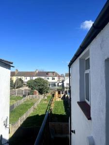 a view of a yard from a balcony of a house at Seaforth Deluxe 2 bedroom apartment at Rockman Luxury Short Stays Lets and Accommodation in Southend-on-Sea