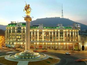 a large building with a fountain in front of it at Room 42 in Tbilisi City