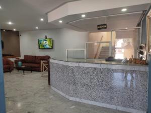 a lobby with a counter and a living room at Hôtel Résidence Louban in Agadir