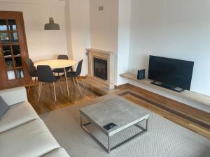 a living room with a couch and a table and a fireplace at ASF Brasil in Lisbon