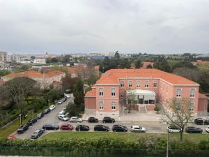 a parking lot with cars parked in front of a building at ASF Brasil in Lisbon
