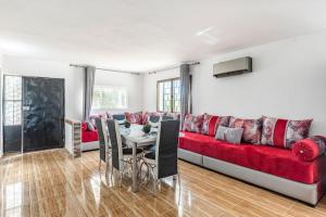 a living room with a red couch and a table at Gîte Nature in Azrou