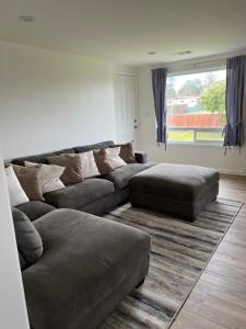 a living room with two couches and a large window at Mckinleyville Farm House in McKinleyville