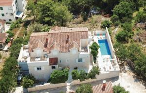 an aerial view of a house with a swimming pool at Family friendly apartments with a swimming pool Supetar, Brac - 16774 in Supetar