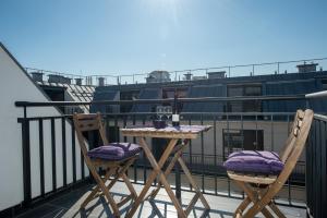 a table and two chairs on a balcony at Budapest Center Executive Apartments in Budapest