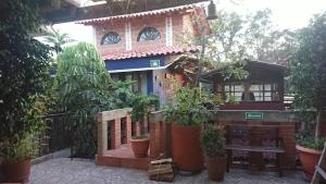 a house with potted plants in front of it at HOSTAL EL REFUGIO in Puebla