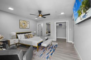 a bedroom with a bed and a living room at Tropical Paradise in Cape Coral