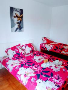 een rood bed met bloemen erop in een kamer bij Holiday house with a parking space Kastel Luksic, Kastela - 20992 in Kaštela