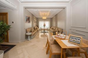 a living room with a couch and a table at Luxury Apartment Airport in Nouaseur