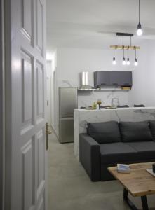 a living room with a couch and a kitchen at Sogni D' Oro "Zen" in Zakynthos Town