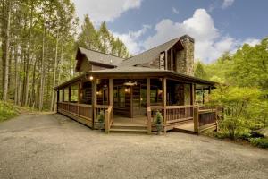 a house with a large porch in the woods at Go Fish- Fightingtown Creek Frontage in McCaysville