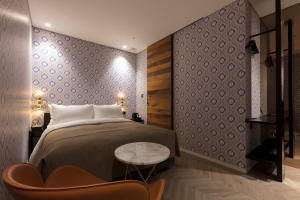 Säng eller sängar i ett rum på Hotel Lemong