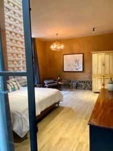 a bedroom with a bed and a chandelier at Casa Patio in San Sebastián del Oeste