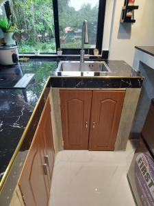 a kitchen with a sink and a counter at Tiny House Loft Style in Digos