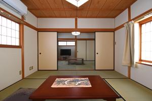 a living room with a table and a tv at 宿樽 in Kanazawa