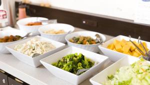 a buffet with bowls of different types of food at Toyoko Inn Hitachi Ekimae in Hitachi
