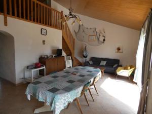 a living room with a table and a couch at Notre-Dame-de-Monts (85) - Maison de vacances 61m² environ - 8 personnes - FR-1-540-164 in Notre-Dame-de-Monts